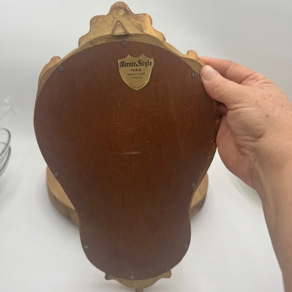 French-style ornate wall mirror, rococo or baroque decorative elements in a gil
